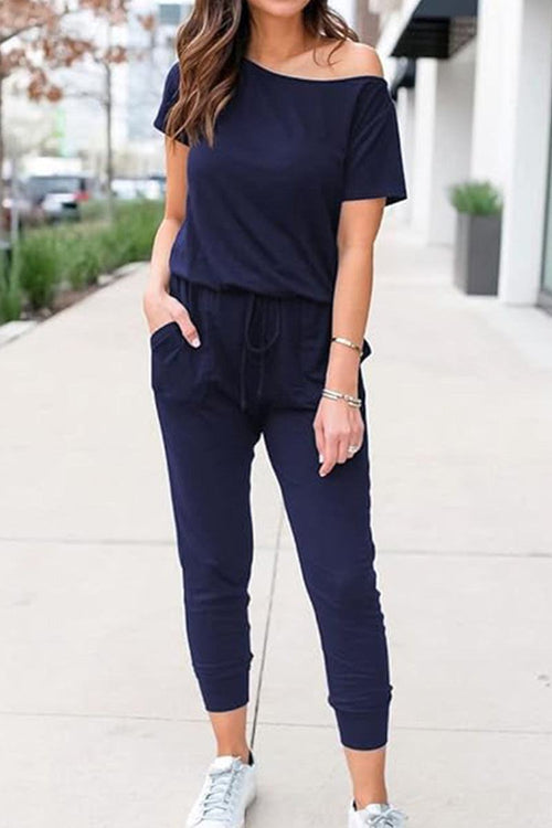 Moonlit Rome Off-Shoulder navy jumpsuit with oblique shoulder design and pockets, casual chic style
