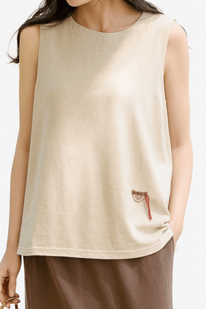 Women's beige sleeveless Dandelion Fields cotton linen top with subtle embroidery, relaxed fit for all-day comfort.