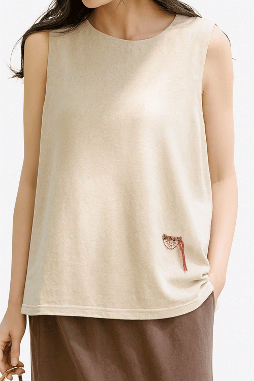 Women's beige sleeveless Dandelion Fields cotton linen top with subtle embroidery, relaxed fit for all-day comfort.