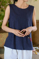 woman wearing navy blue Dandelion Fields cotton linen sleeveless top with embroidered detail