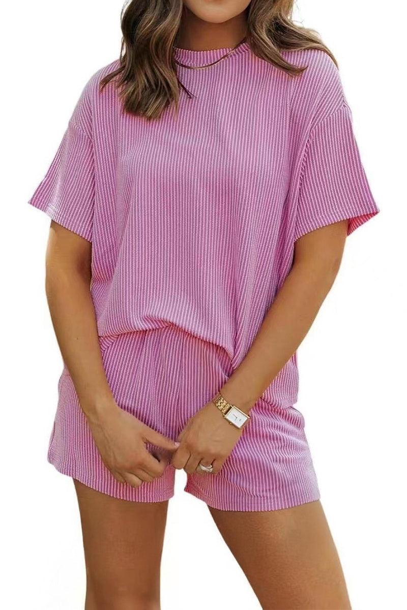Woman wearing a soft textured pink relaxed-fit t-shirt and shorts set for slow mornings and casual comfort