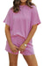 Woman wearing a soft textured pink relaxed-fit t-shirt and shorts set for slow mornings and casual comfort