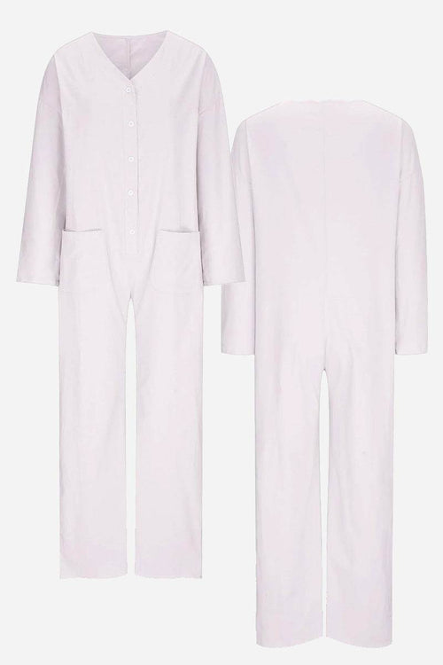 Front and back view of a light lavender relaxed jumpsuit with button-front, long sleeves, and pockets