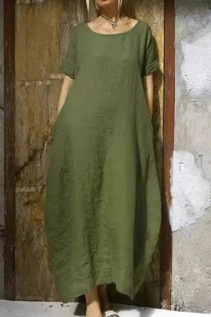 Olive green Breeze Cocoon Dress with relaxed fit, rolled sleeves, and deep side pockets in breathable linen-like fabric.
