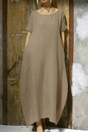 Breeze Cocoon Dress in beige linen-like fabric with rolled sleeves and relaxed airy silhouette.