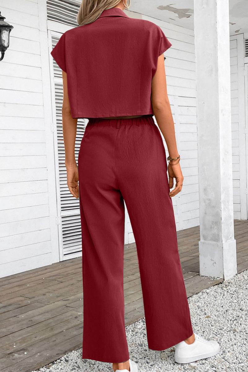Back view of woman wearing maroon two-piece set with big functional pockets and wide-leg pants outdoors