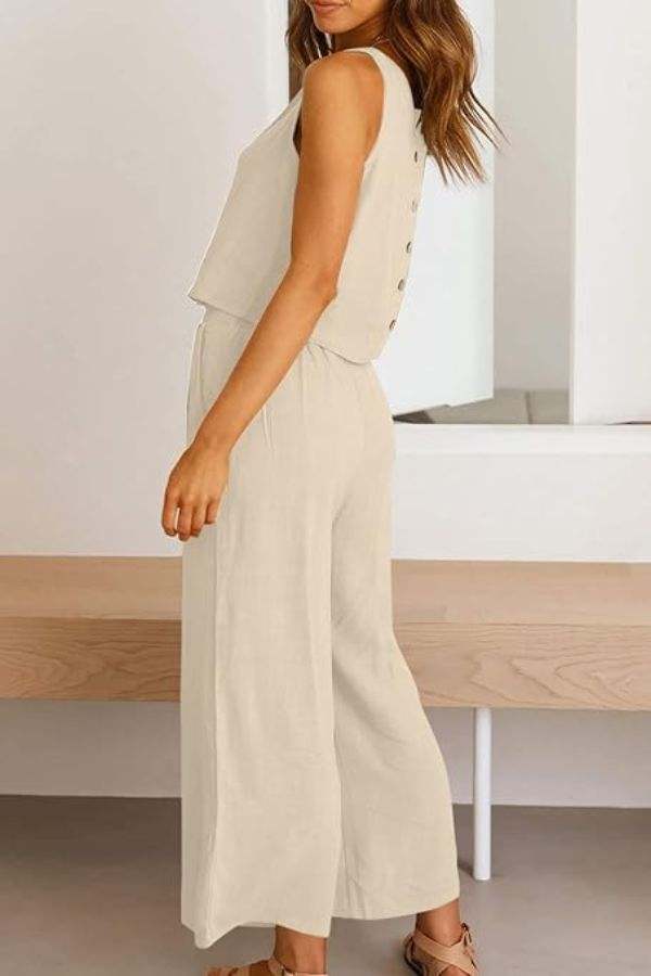 Woman wearing beige Villa Lounge Linen Set sleeveless crop top and wide-leg pants with elastic waistband and side pockets