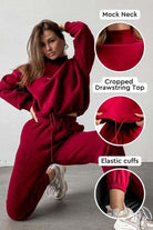 Woman wearing red Storm Sweater Mock Neck athleisure set with cropped drawstring top and elastic cuffs.