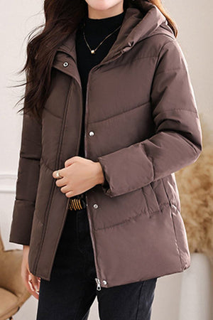 Mid-length Everyday Warmth Coat in brown with hood, lightweight 5-layer thermal insulation, wind-resistant polyester shell, softly shaped silhouette, and deep pockets.