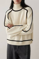 Cream Zero Itch Turtleneck Sweater with black contrast trim and relaxed fit