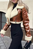 Women's cropped faux leather sherpa jacket with cream trim and zip front closure