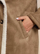 Faux suede sherpa coat with contrast trim and double-breasted front, mid-thigh length, lightweight and relaxed fit for layering.