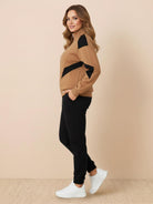 Woman wearing a colorblock comfort tracksuit with contrast curved panels and relaxed fit