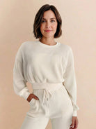 Woman wearing a breathable 100% cotton waffle knit set with long sleeves and high-waisted pants.