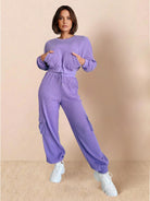 Woman wearing lavender cotton waffle knit set with long sleeves, cargo pockets, and elastic cuffs