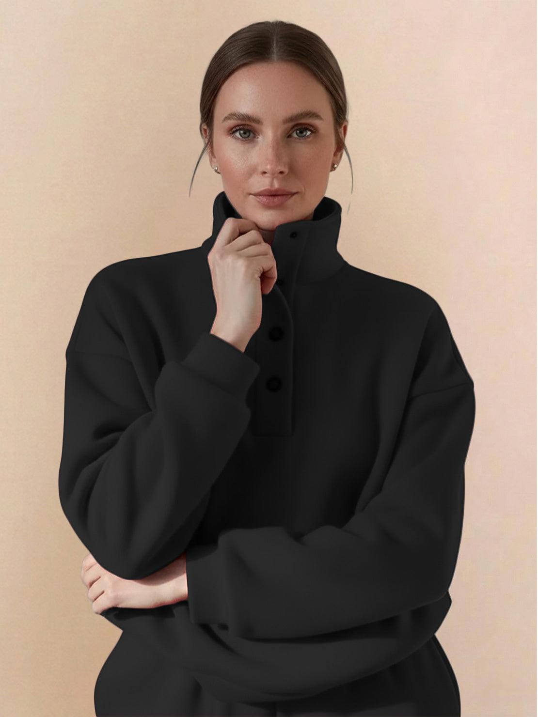 Woman wearing a black Warm & Easy Two-Piece Set pullover hoodie with button-collar and relaxed fit.