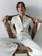 Black ribbed zip-up knit cardigan jacket with high neckline and long sleeves