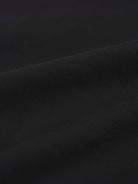 Wrinkle-free polo set with quarter-button top and high-waisted pants in breathable structured fabric