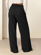 Soft knit wide-leg pants with elastic waistband and side pockets in breathable fabric