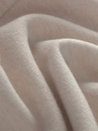 Close-up of soft beige thermal wool blend fabric for warm trousers