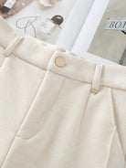 close-up of cream thermal wool blend trousers with button and belt loops for comfortable wide-leg winter wear