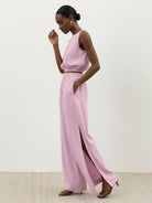 Women wearing a lightweight linen-blend set with sleeveless top and wide-leg pants featuring side slits and elastic waistband