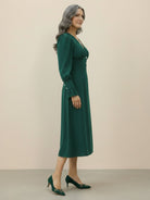 Slimming V-neck midi dress with button front, long ruffle sleeves, defined waist, and A-line skirt.