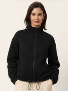 Cropped textured baseball jacket with full zipper, stand collar, elastic cuffs, and waistband.