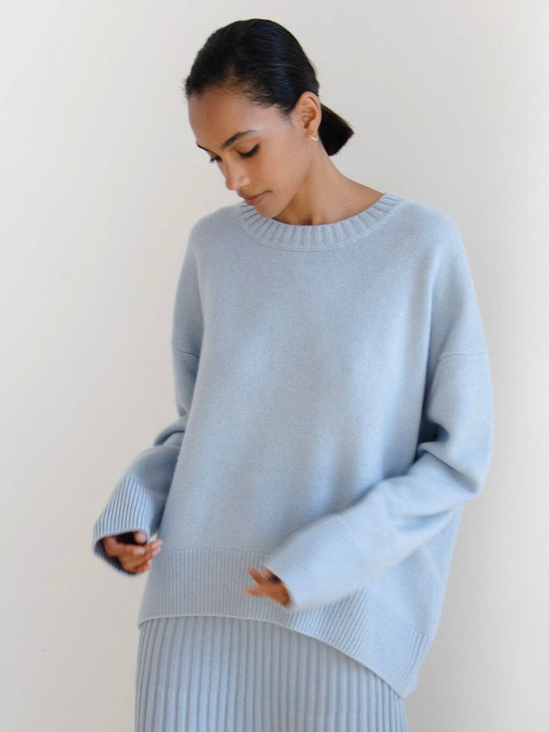 Oversized crew neck knit sweater with dropped shoulders and ribbed cuffs in neutral color