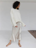Oversized crew neck knit sweater with drop-shoulder sleeves and ribbed cuffs in neutral color
