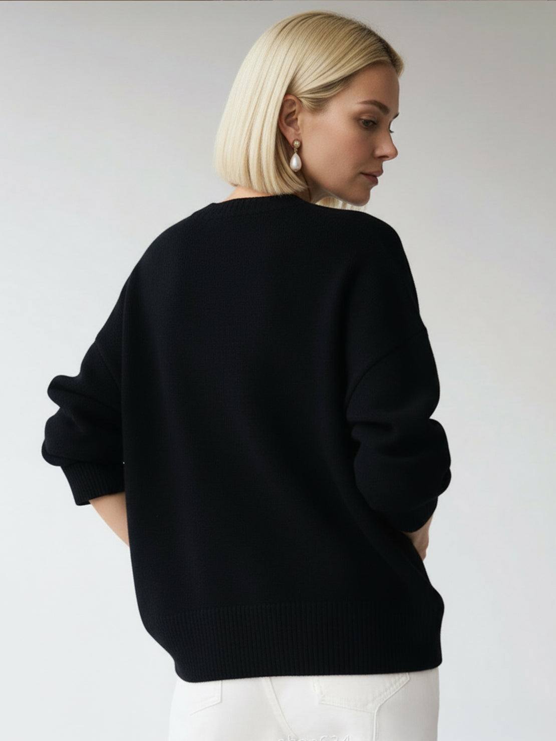 Oversized crew neck knit sweater with dropped shoulders and ribbed cuffs in neutral color