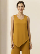 Woman wearing open-front three-piece co-ord with longline cardigan, tank top, and wide-leg trousers