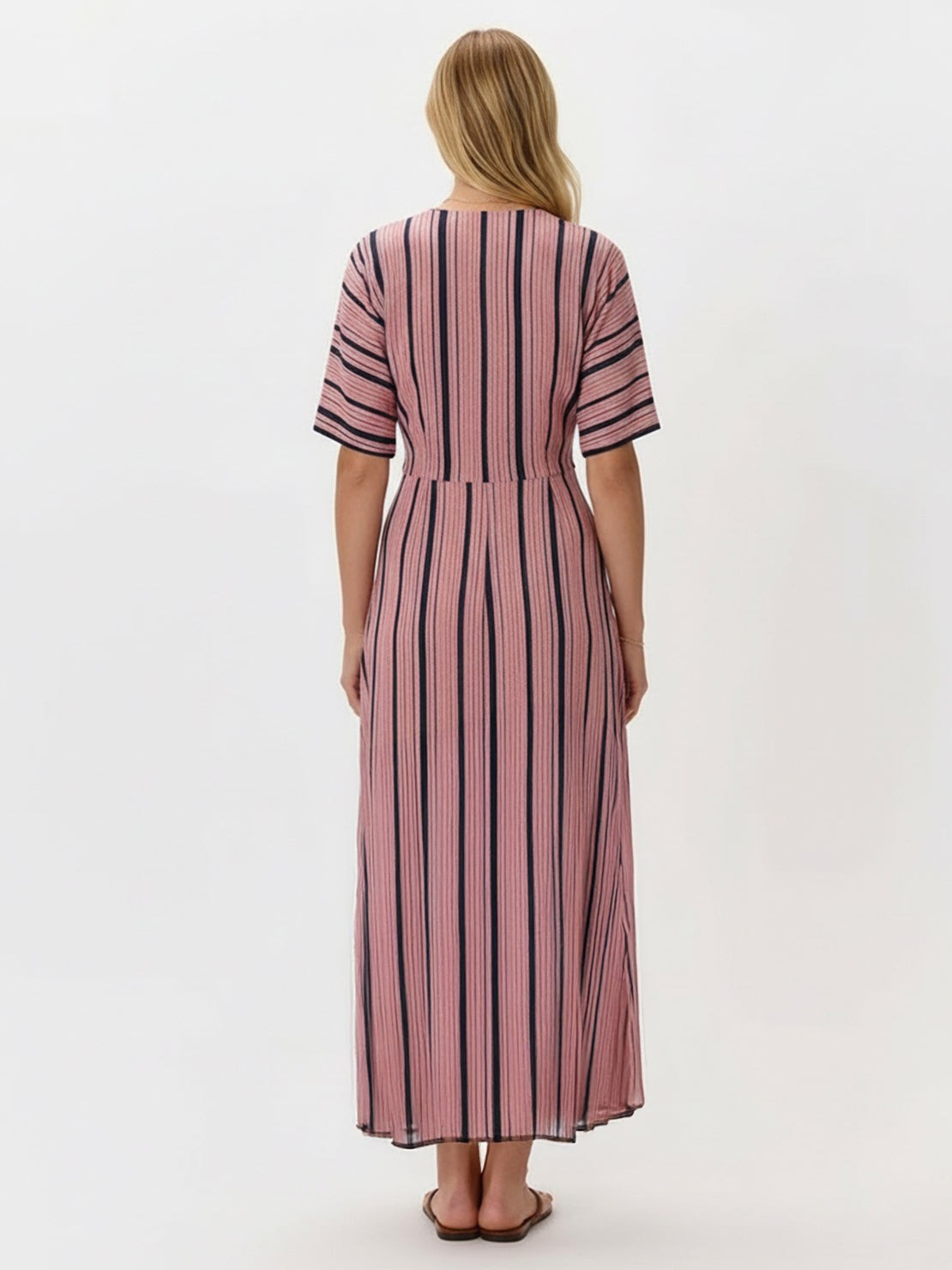 Woman wearing a flowing knot-waist maxi dress with V-neckline and batwing sleeves