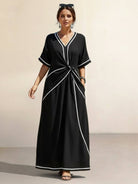 Knot-waist maxi dress with twist-knot detail, V-neckline, batwing sleeves, flowing skirt, and side pockets.