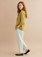 Cotton-linen blazer with notch lapels, two-button closure, and relaxed fit on natural textured fabric.