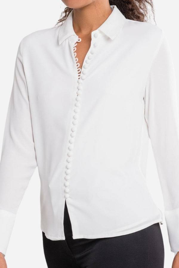 White Bayam Blouse with button detail and classic collar, long sleeves, made of 100% polyester.