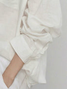 White oversized 100% cotton-linen shirt with dropped shoulders and curved hem