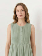 Sleeveless cotton linen pleated midi dress with pintuck bodice and full A-line skirt in white