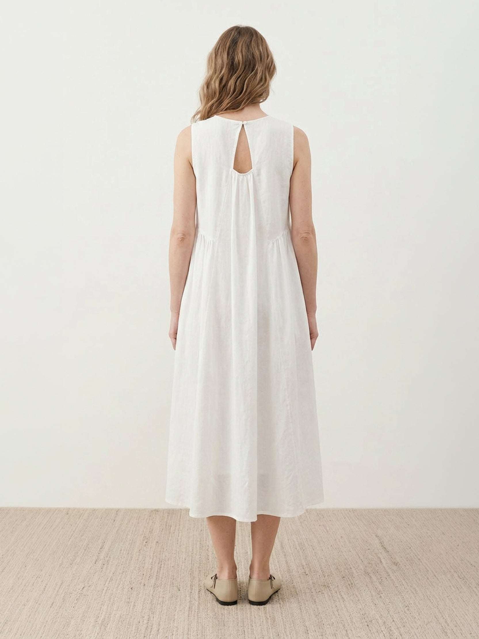 Sleeveless cotton linen pleated midi dress with pintuck bodice and full A-line calf-length skirt