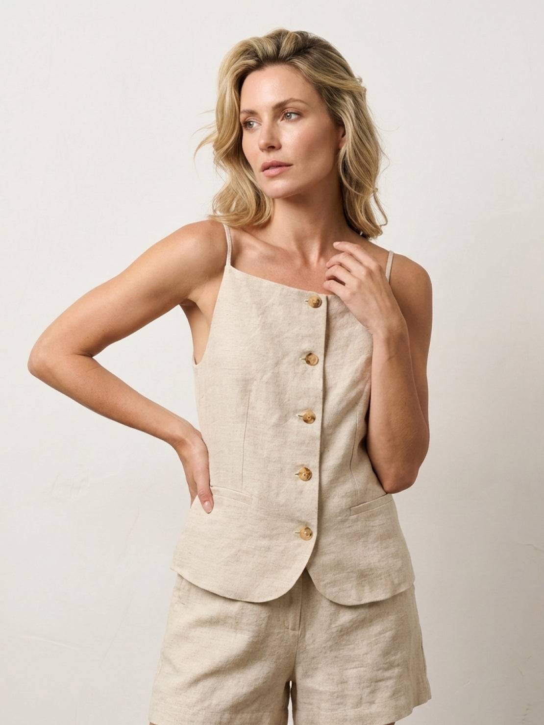 100% linen yarn-dyed vest with fitted shape, square neckline, button-front, and welt pockets