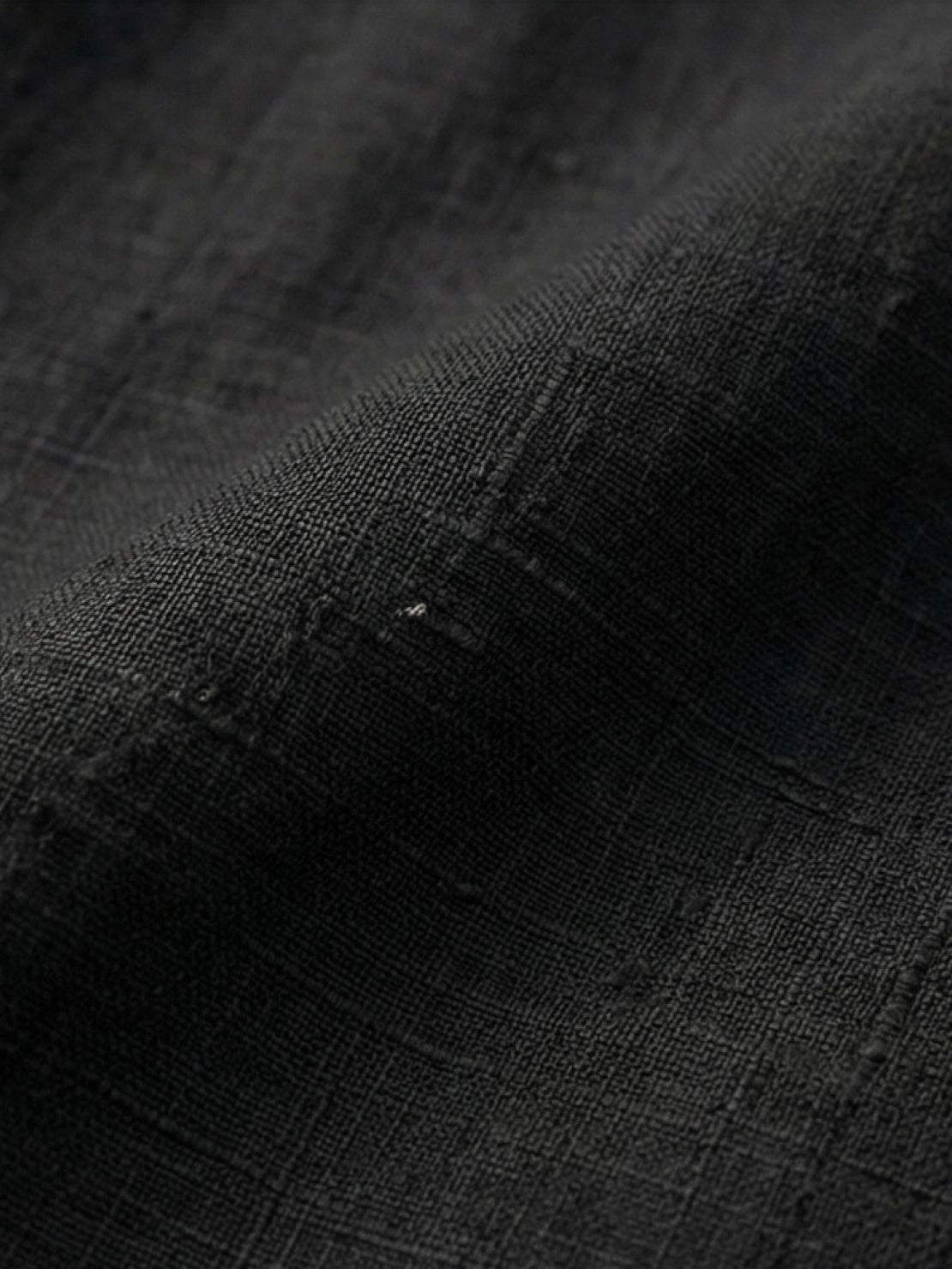 White Tencel-linen pleated wide-leg pants with structured waist and flowy silhouette