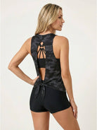 Three-piece open-back swim set with loose tank, racerback crop bra, and boy-short swim shorts