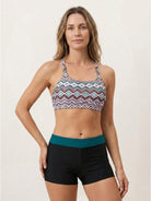 Three-piece open-back swim set with loose tank, racerback crop bra, and mid-rise swim shorts