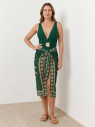 Deep-V swimsuit with ruching, gold shell detail, and sheer celestial print sarong wrap