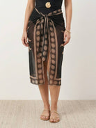 Deep-V swimsuit with ruched bust and waist, wide straps, low back, and sheer celestial print sarong wrap