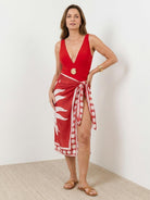 One-piece deep-V swimsuit with ruching and sheer printed sarong wrap