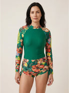 Tropical print rash guard set with long-sleeve top and boy-cut swim shorts featuring high mock neckline and hip ties