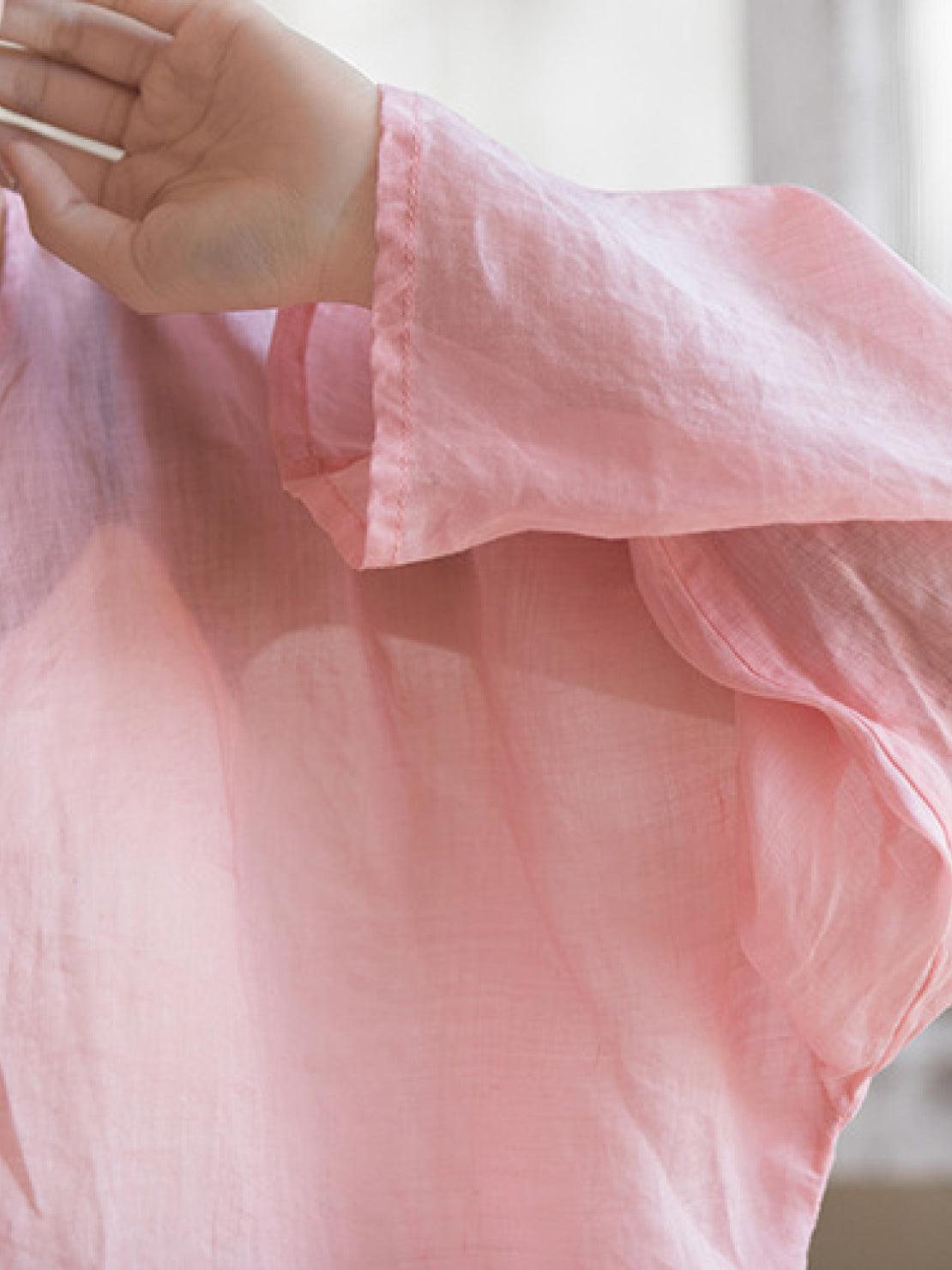 Oversized 100% linen blouse with frog buttons, long sleeves, curved hem, and collarless neckline in lightweight fabric