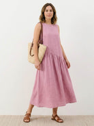 Lightweight cotton-linen summer midi dress with tiered skirt and relaxed drop-waist silhouette in natural fabric texture