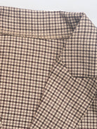 Black and white houndstooth commuter blazer with structured shoulders and relaxed fit